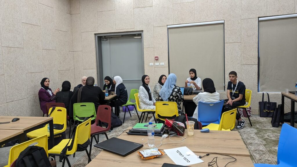 A group of Bedouin high school students sitting in groups.