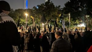 Group of people at protest at night.